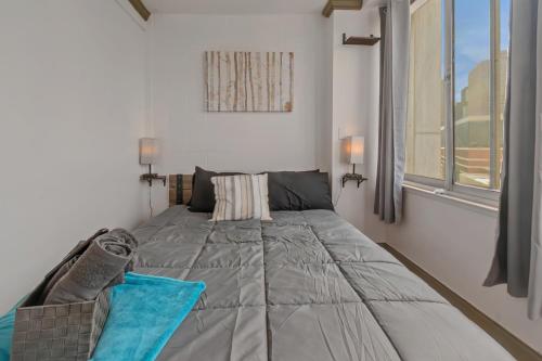 a bed in a room with a large window at Modern 3BR Condo - Heart of ATL in Atlanta