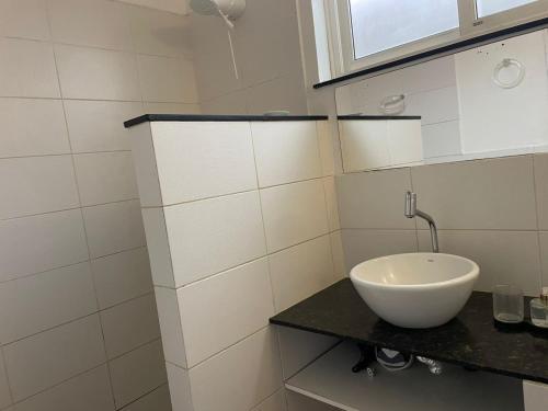 a bathroom with a bowl sink on a counter at WB04 Loft Aconchegante Passos da Rua das Pedras ! in Búzios