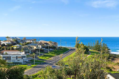 an aerial view of a road in front of the ocean at 11 Warbler Crescent in Kianga