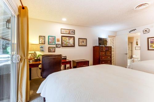 a bedroom with a bed and a desk and a chair at 2 Mi to Galleta Meadows Desert Golf Retreat! in Borrego Springs