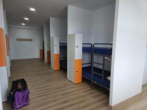 a row of bunk beds in a dorm room at Albergue Camping de Castro in Castro-Urdiales
