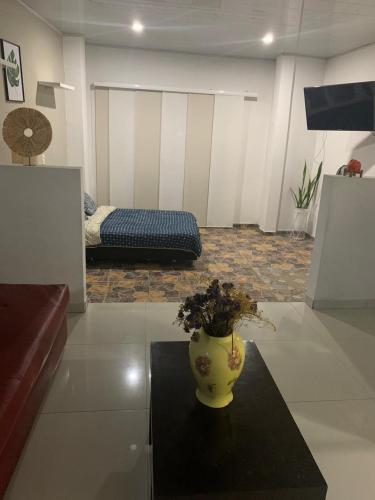 a living room with a vase sitting on a table at casa hacienda tranquilidad in Estación El Salto