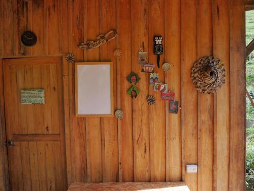 a wooden wall with a door and some decorations at Hostal El Silencio Vivo in San Rafael