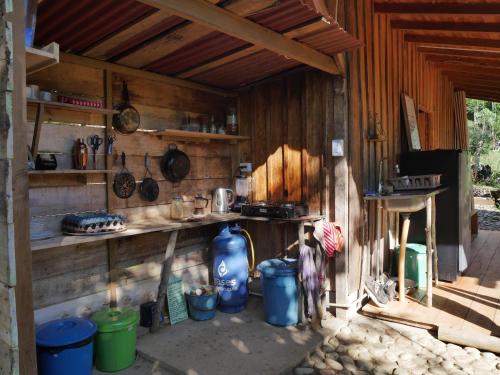 a person standing in a kitchen with pots and pans at Hostal El Silencio Vivo in San Rafael