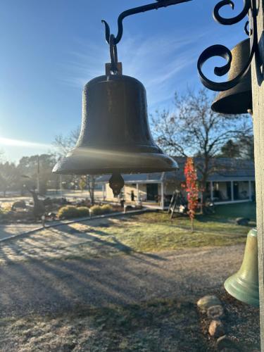 a bell hanging from the side of a building at Tell Tales Bed & Breakfast in Creswick