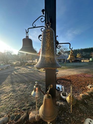 a group of bells hanging from a pole at Tell Tales Bed & Breakfast in Creswick