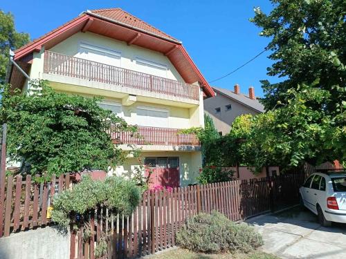 a house with a fence in front of it at Apartment Siofok, Somogy 7 in Siófok