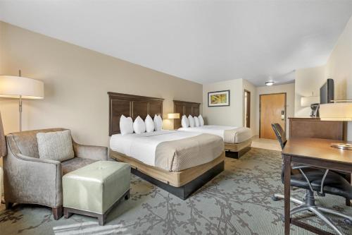 a large hotel room with a bed and a desk and a desk at Best Western Black Hills Lodge in Spearfish