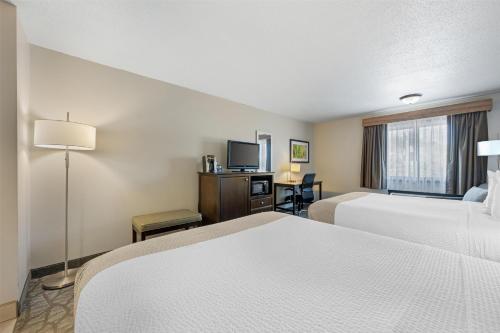 a hotel room with two beds and a television at Best Western Black Hills Lodge in Spearfish
