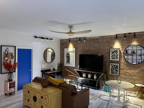 a living room with a couch and a tv at Park Slope New Pvt 2 bdrm in Brooklyn