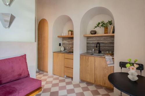 a living room with a couch and a kitchen at Design & Timeless Charm Casa Serapio - Residence1 in Mexico City