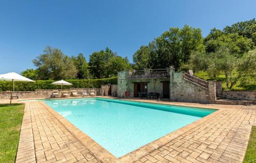a swimming pool in a yard with a stone building at Lorenzo in Acqualoreto