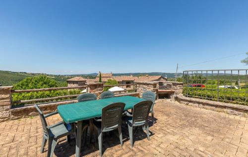 a green table and chairs on a brick patio at Lorenzo in Acqualoreto