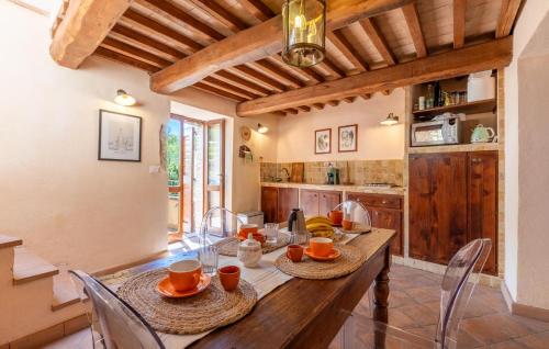 a kitchen with a wooden table and chairs in a room at Lorenzo in Acqualoreto