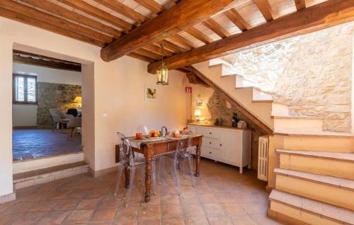 a kitchen with a wooden table and a staircase at Lorenzo in Acqualoreto