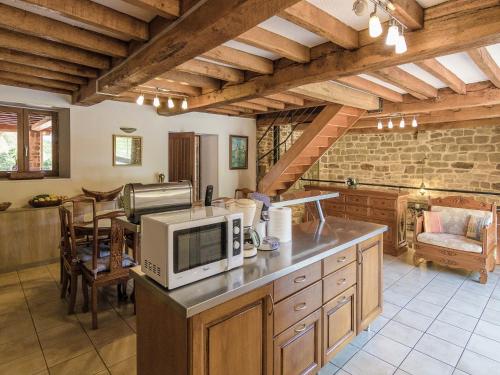 une cuisine avec un four micro-ondes au-dessus d'un comptoir dans l'établissement Villa in Sérilhac with Private Pool, cleaning included, à Sérilhac