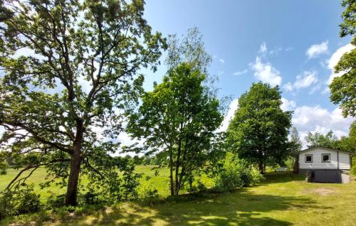 a house in the middle of a field with trees at Stunning Home In Gashult With Wifi in Gashult