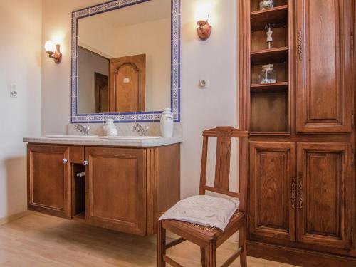 une salle de bain avec un lavabo, un miroir et une chaise dans l'établissement Villa in Saint-Bonnet with Private Pool, cleaning included, à Saint-Bonnet-la-Rivière