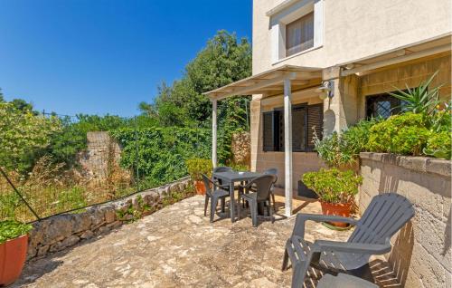 a patio with chairs and a table in front of a house at Casal Del Borgo 3 in Ostuni