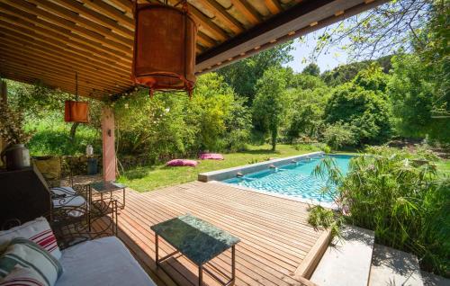 a wooden deck with a swimming pool in a yard at Cerasuola in Alia