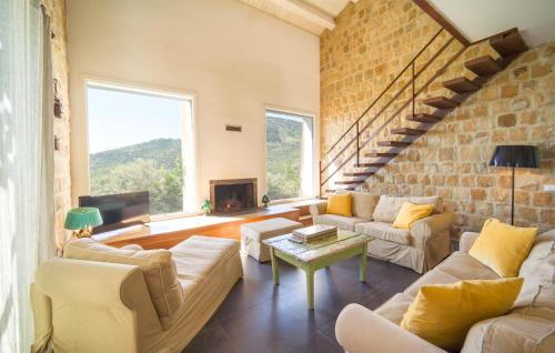 a living room with couches and a brick wall at Cerasuola in Alia