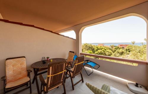 a room with a table and chairs and a window at 2 Bedroom Lovely Apartment In Mandre in Mandre