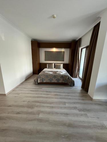 a bedroom with a bed in the middle of a room at Small Beach Hotel in Bodrum City