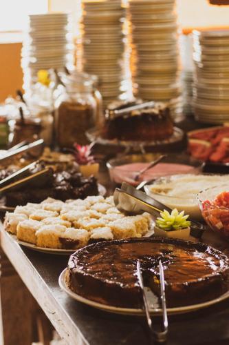 a buffet of food with chocolate cakes and pastries at Lonier Nature INN in Abraão