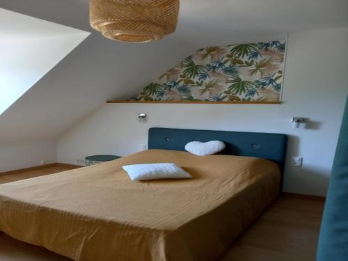 une chambre avec un lit avec deux oreillers dessus dans l'établissement Holiday Home in Epiniac near Mont-St-Michel, cleaning included, à Epiniac