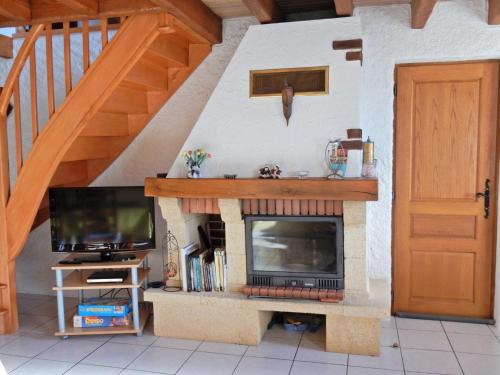 un salon avec une cheminée et une télévision dans l'établissement Holiday Home in Vosges with Garden and BBQ, cleaning included, à Le Haut-du-Them