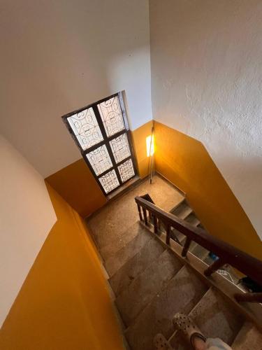 an overhead view of a staircase with a window at Room in Traditional Nepali house in Kathmandu