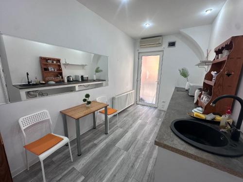 a kitchen and living room with a table and chairs at Ultra Central Piata Libertatii Apartment in Timişoara