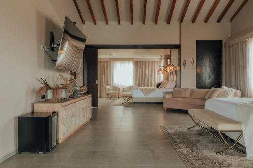 a living room with a bed and a couch at Tau House in Guatapé