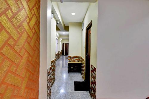 a hallway with stairs and a wooden door at Hotel O Parasol Inn Gangtok in Gangtok