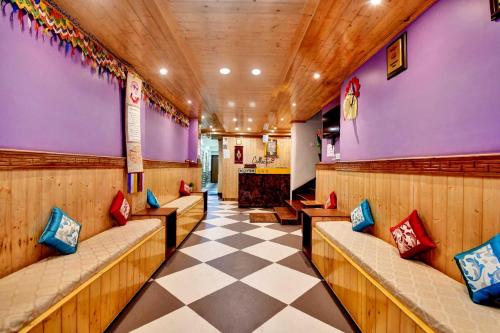 a waiting room with benches and a checkered floor at Hotel O Parasol Inn Gangtok in Gangtok