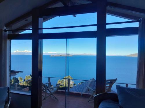 a room with a view of the water through a window at Sol y Luna - ISLA DEL SOL in Comunidad Yumani
