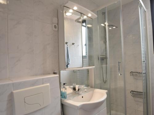 une salle de bain blanche avec un lavabo et une douche dans l'établissement Villa in Saint-Cyprien with Sea View, cleaning included, à Saint Cyprien Plage