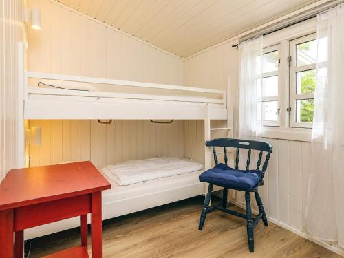 a desk and a chair in a room with bunk beds at 6 person holiday home in Løkken in Løkken