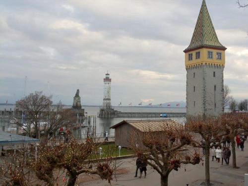 a large building with a tower with a green roof at Fischer - Lindau Island in Lindau