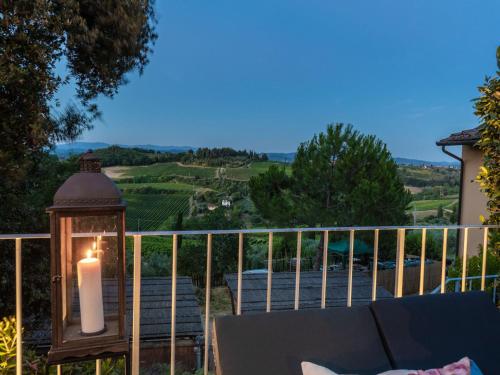 a candle on a porch with a view of a vineyard at Idyllic Coastal Escape in Sardinia in Marcialla
