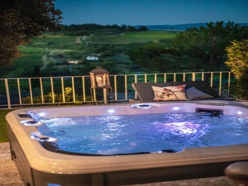 a jacuzzi tub with a view of a golf course at Idyllic Coastal Escape in Sardinia in Marcialla