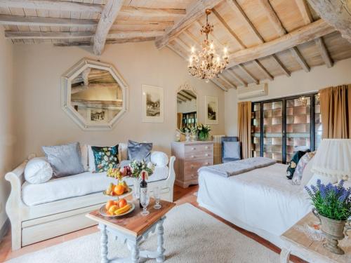 a living room with a couch and a table at Tuscan Farmhouse with Infinity Pool Retreat in Matraia