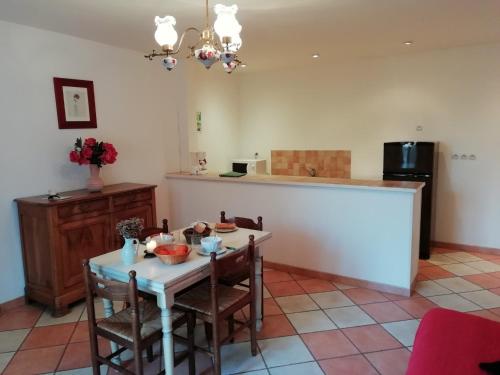 une cuisine avec une table, des chaises et un comptoir dans l'établissement Quend-Plage Apartment with Pool, cleaning included, à Quend-Plage