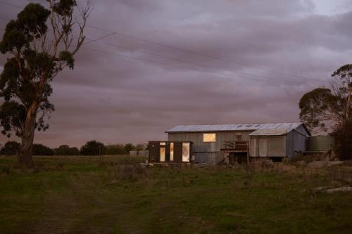 an old house in the middle of a field at Farm Stay Tiny House by Tiny Away in Braidwood