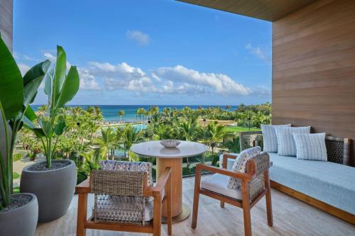 a living room with a couch and a table and chairs at The St. Regis Cap Cana Resort in Punta Cana