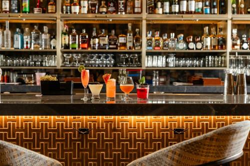 a bar with three cocktails on a counter at Renaissance Dallas Hotel in Dallas