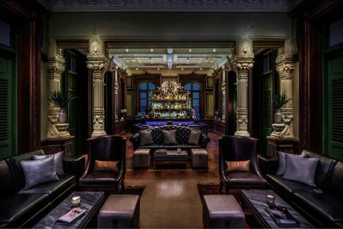 a living room with a couch and a chandelier at W Bangkok Hotel in Bangkok