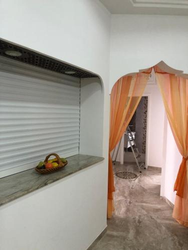 a mirror on a wall next to a room at 1 Sweet & Spacious House in Hammamet tunisia in Hammamet