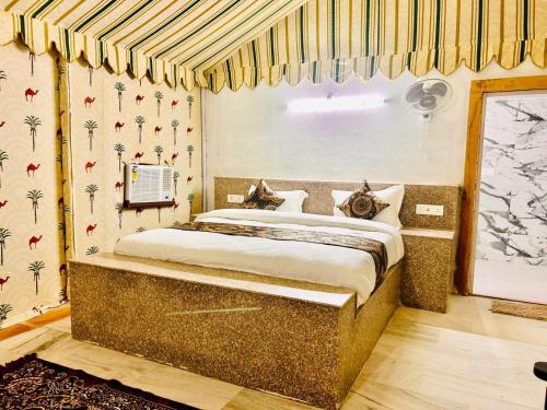 a bedroom with a large bed in a room at Jaisalmer Sand Dunes Luxury Camp And Resort in Jaisalmer