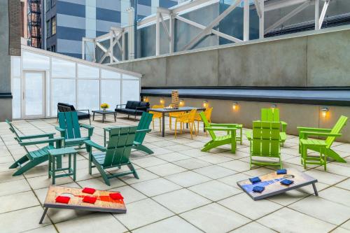 a patio with colorful chairs and tables on a building at Aloft New York Brooklyn in Brooklyn